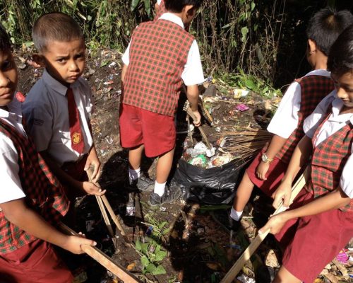 children cleaning rubbish up