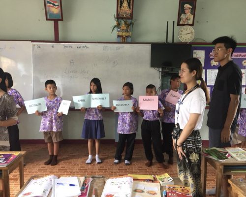 kids holding up month signs