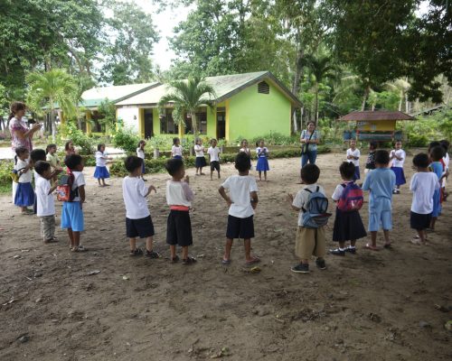 Students gathered in a cirlce singing songs