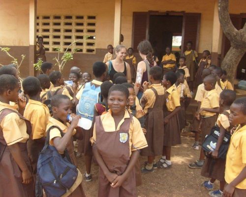 class standing outside school in Ghana