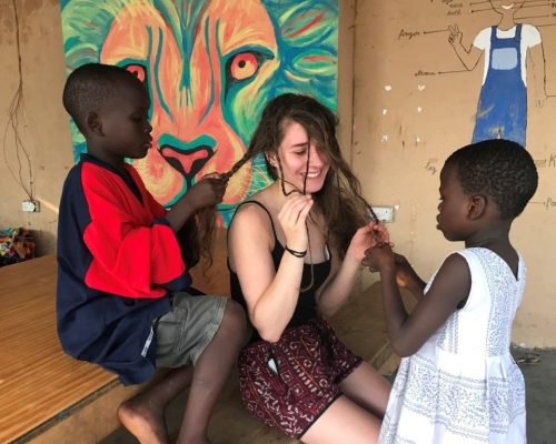 Children braiding girls hair