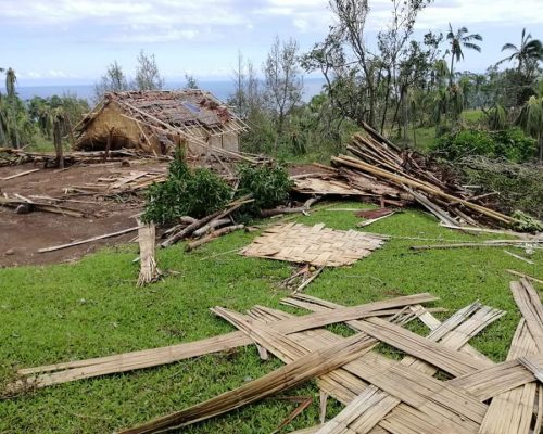 walls of straw house sprawled on grass