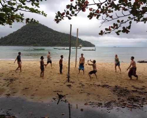 playing volleyball at the beach with new friends