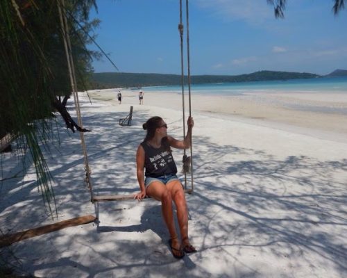 at the beach on a swing