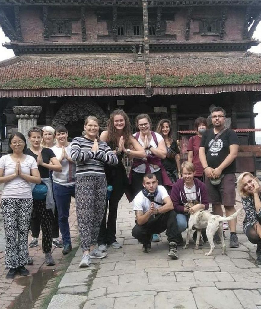 group pic by temple in Nepal