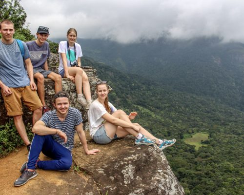 group sitting at top of viewpiont