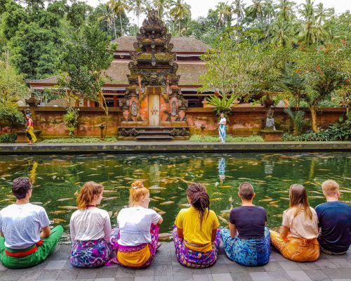 group sitting in front of temple