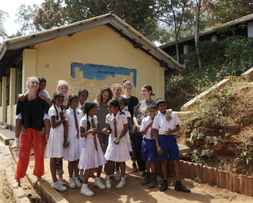 group with school kids at renovation project