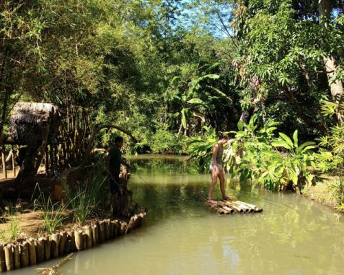 standing on bamboo raft