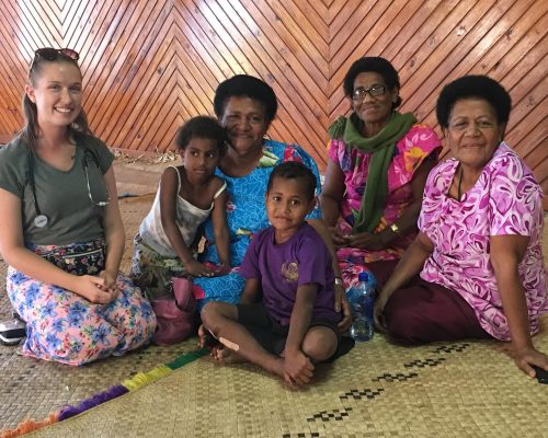 lovely shot with volunteer health worker and fijian woman and children