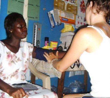 taking blood pressure of local woman