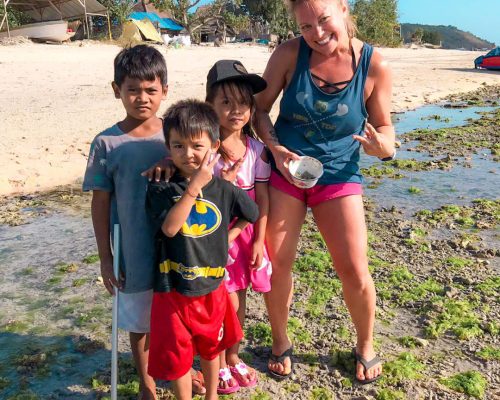 posing with local children at the beach