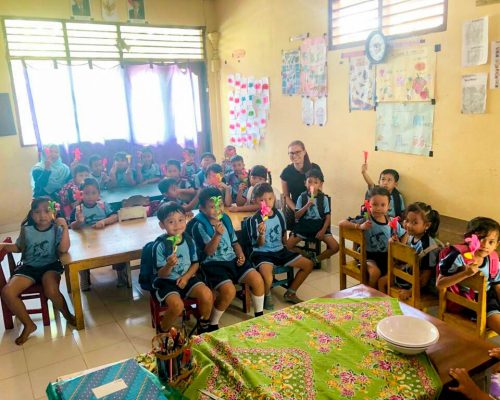 pre school children holding handmade flowers