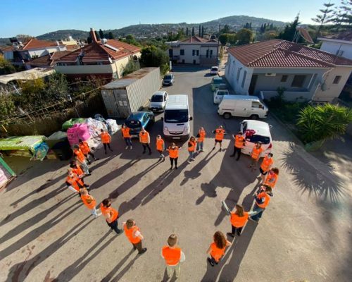 refugee volunteers making a heart shape