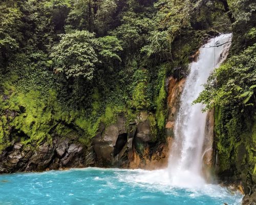 waterfall into blue pool