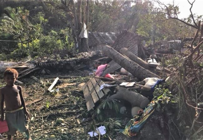 boy by vanuatu cyclone damage