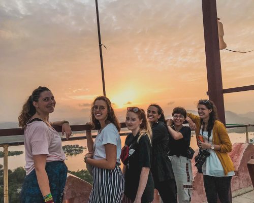 volunteers in front of sunset in India